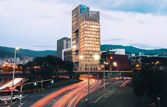 Skyline moderne de Medellín au crépuscule avec des gratte-ciel illuminés et des feux de circulation